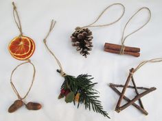 christmas decorations made from cinnamon sticks, orange slices and pine cones are arranged on a white background