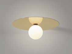 a white ceiling light with a round glass shade on it's center point and an oval shaped lens at the top