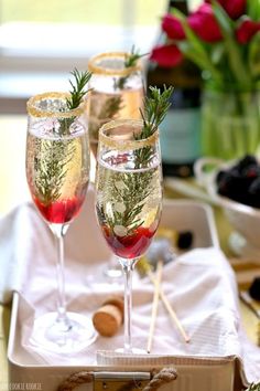 two glasses of wine sitting on top of a table