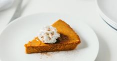 a slice of pumpkin pie with whipped cream on top