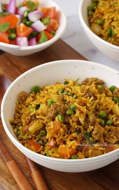 two white bowls filled with rice and vegetables