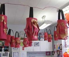 several red umbrellas hanging from the ceiling