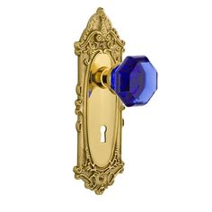 an ornate door handle with a blue glass knob on the front and back of it