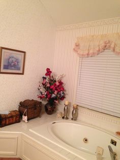 a white bath tub sitting next to a window