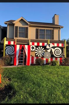 a house decorated for halloween with giant candy canes