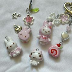 some cute little key chains on a white sheet