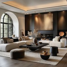 a large living room with black and white furniture