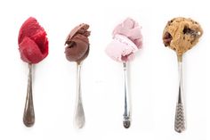 four spoons with different types of ice cream on them