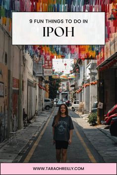 a woman walking down an alley way with the words 9 fun things to do in ipoh