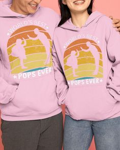 two people standing next to each other wearing pink hoodies with the words world's best pops ever on them