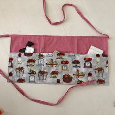 a red and white checkered apron with cupcakes on it