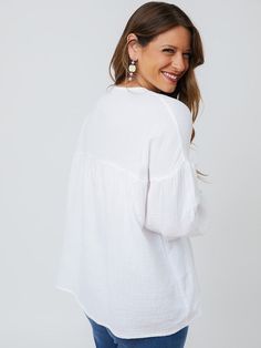 Cut from a soft, gauzy white cotton, this boho top makes every day feel like a beach day. There's something about an effortless statement earring that really brings out the best in this lightweight top with an easy fit. Fit Note: Designed to be roomy and flowy. Those that prefer a more fitted garment or that are in between sizes will want to size down 100% cotton Length of size M is 27" from top of bodice Made fair trade in India by one of our longstanding production partners Effortless Long Sleeve Beach Blouse, Cotton V-neck Peasant Top For Vacation, Effortless Long Sleeve Blouse For Beach, Breezy Long Sleeve Top For Vacation, Flowy Breezy Tops For Day Out, Spring Cotton Gauze Blouse, Flowy Long Sleeve Breezy Top, Flowy Cotton Tops For Daywear, Breezy Long Sleeve Flowy Top