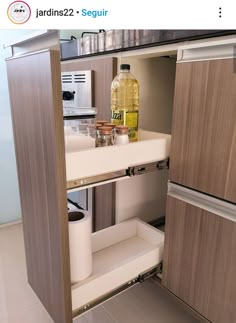 an open cabinet in a kitchen filled with bottles and other household items on the counter