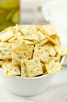 a white bowl filled with crackers on top of a table