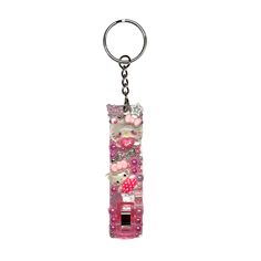 a keychain that is shaped like a car with hello kitty decorations on it