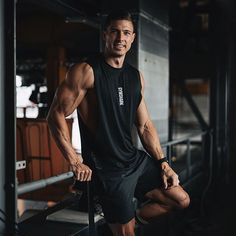 a man posing for a photo in the gym