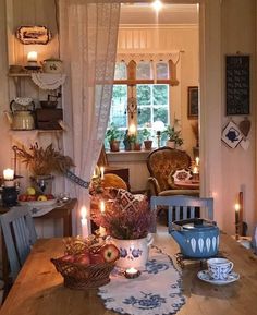 a wooden table topped with dishes and candles