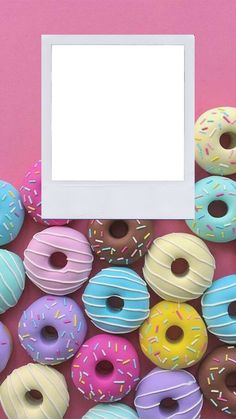 there are many different donuts in front of a white square frame on the pink background