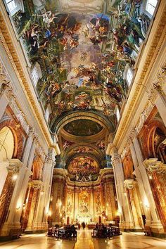 the interior of a church with many paintings on the ceiling