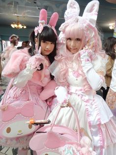 two women dressed in bunny costumes posing for the camera