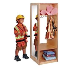 a young boy standing in front of a wooden locker