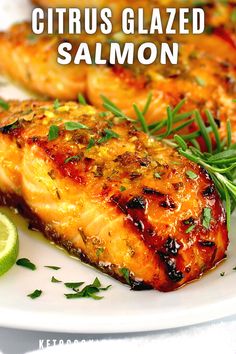 grilled citrus glazed salmon on a white plate with garnish and lime wedges