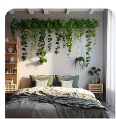 a bed covered in lots of green plants next to a wall mounted with hanging planters