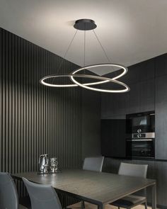 a modern dining room with black walls and chairs