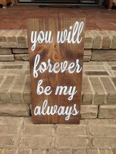 a wooden sign that says you will forever be my always on the side of a brick wall