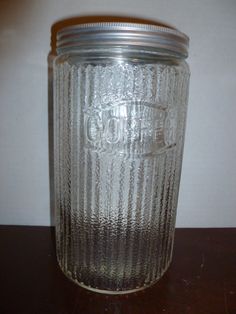 a glass jar sitting on top of a wooden table