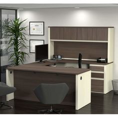 an office cubicle with desk, chair and computer