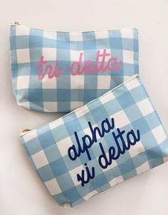 two blue and white checkered bags with embroidered words