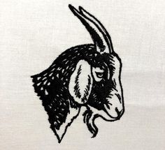 a black and white drawing of a goat's head on a white cloth background