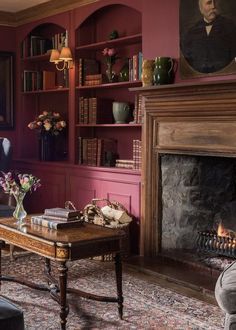 a living room filled with furniture and a fire place in front of a book shelf