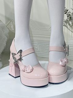 a close up of a person's legs wearing pink shoes