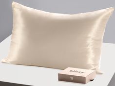 a pillow and box sitting on a table