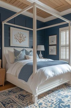 a bedroom with blue walls, white bedding and wooden ceiling beams is pictured in this image