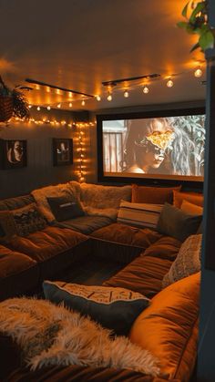 a living room filled with lots of couches and a flat screen tv mounted to the wall