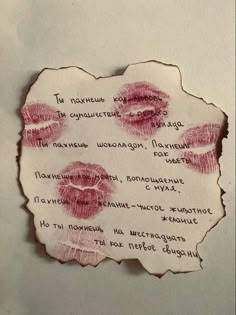 a piece of paper with red lipstick imprints on it and words written in different languages