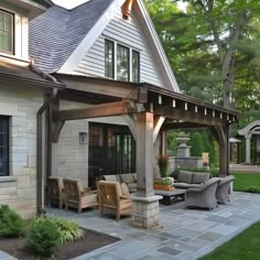 an outdoor living area with furniture and landscaping