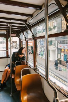 a woman sitting on a bus looking out the window