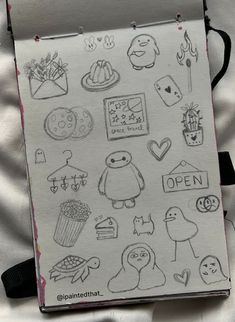 an open notebook with drawings on it