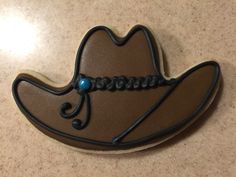 a cookie shaped like a cowboy's hat with beads