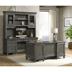 an office desk and hutch in a room