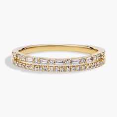 a yellow gold ring with three rows of diamonds on the side and one row of white stones