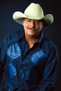 a man wearing a cowboy hat and blue shirt