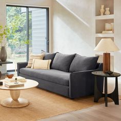 a living room filled with furniture and a large window