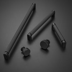 three different types of earbuds on a black surface with two metal headset plugs