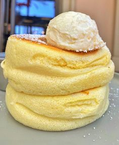 a stack of yellow pancakes with ice cream on top