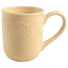 a cream colored coffee cup with white dots